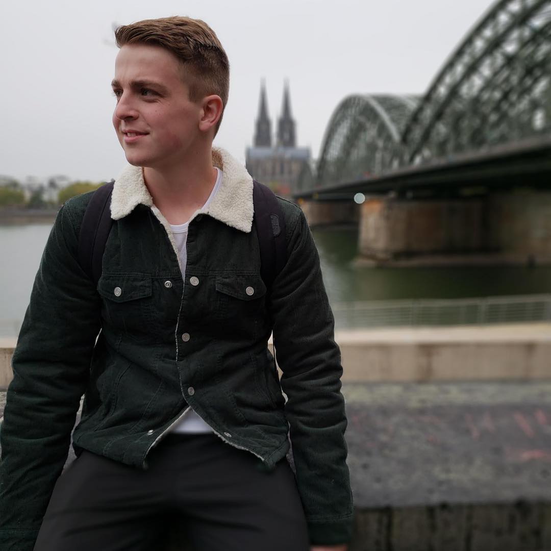 Timothy Miller in Cologne, Germany with the Cologne Cathedral in pictured in the background